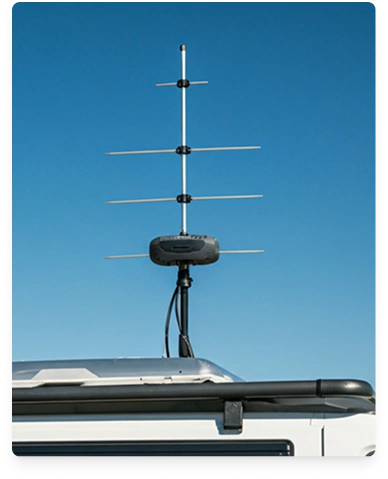 External antenna mounted on a vehicle roof against a blue sky